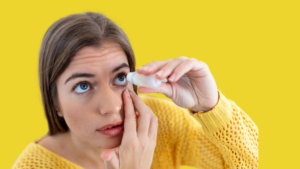 Frau macht sich Augentropfen ins Auge
